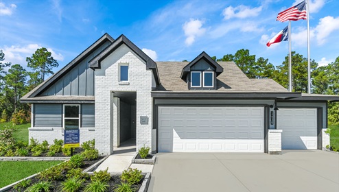 Holly Trails model home exterior elevation front view with two car garage.