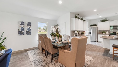 Holly Trails model home dining room with view of the kitchen.