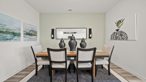China Grove model home dining room table with accents for decor.