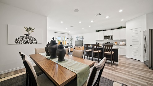 China Grove model home dining room table with view into kitchen.