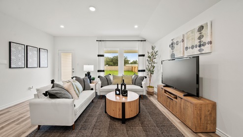 China Grove model home living room furnished with modern accents and vinyl plank flooring.