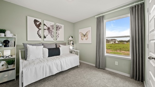 China Grove model home secondary room with daybed and butterfly accents for decor.