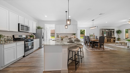 Windemere model home kitchen with open concept of the dining and living room.
