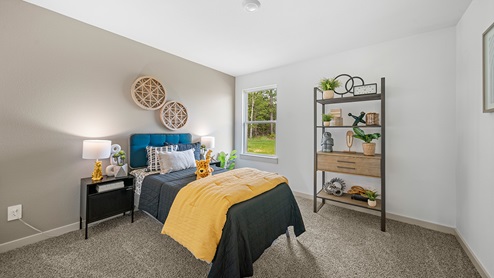 Windemere model home secondary bedroom with a twin-size bed and carpet flooring.
