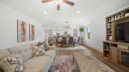Windemere model home living room with open concept of the dining room and kitchen.