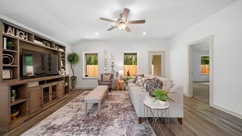 Windemere model home living room with view of the backyard and back door.