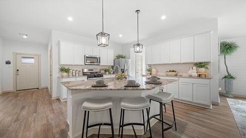 Windemere model home kitchen with white cabinets and granite countertops.
