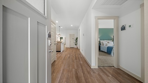 Windemere model home front entry with a view of the kitchen and secondary bedroom.