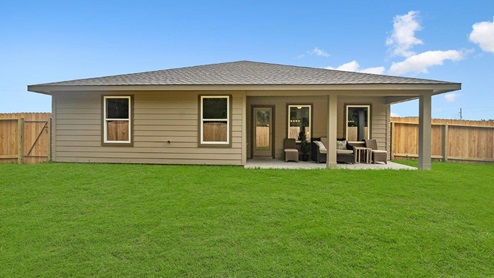 Windemere model home backyard with a view of the back patio and back door.