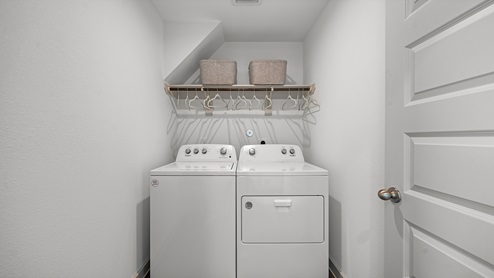 Windemere model home utility room with washer and dryer.