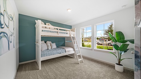 Windemere model home secondary bedroom with twin bunk beds and carpet flooring.