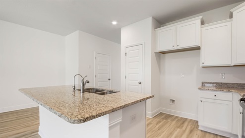 Kitchen with upper and lower cabinetry