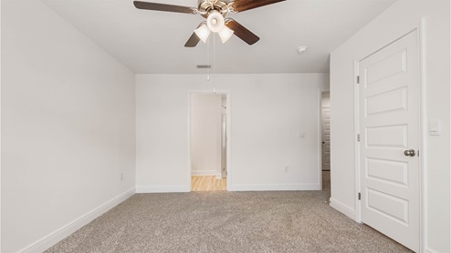 Primary bedroom features the closet with upper ventilated shelving