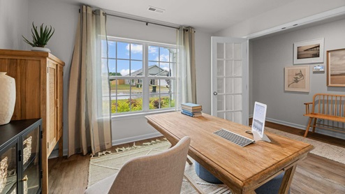 Office with large window for natural light and double french doors