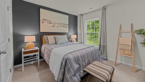 Bedroom with carpet flooring and blue accent walls