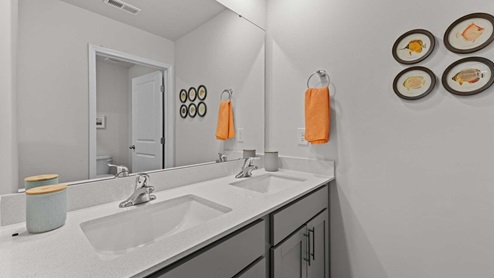 bathroom with quartz countertops and double sinks