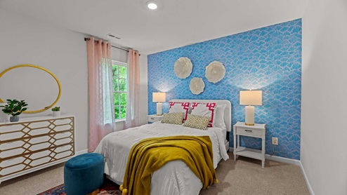 bedroom with blue accent wall and carpet flooring