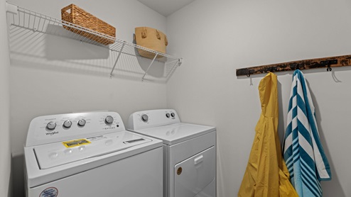 Laundry room with washing machine and dryer with built in wire shelving