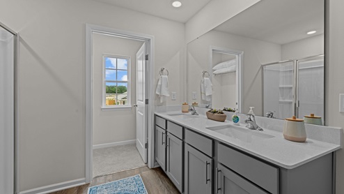 Primary bathroom with quartz countertops and double sinks