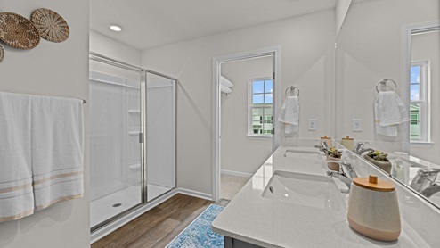 Primary bathroom with quartz countertops and double sinks