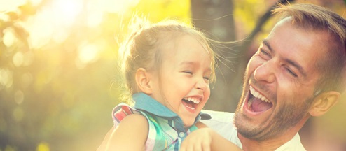 father laughing with baby