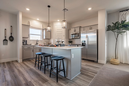 Spacious kitchen with pendant lighting and island seating