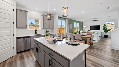 Open concept kitchen with an island and barstools