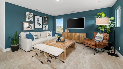 Upstairs loft with couch, TV, and decor