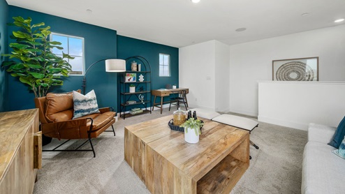 Upstairs loft with couch, TV, and decor