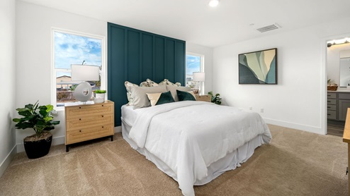 Primary bedroom with large windows on both sides of bed