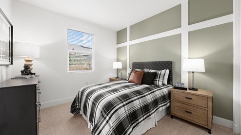 Interior photo of guest bedroom with green accent wall