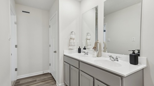 Secondary full bath with white counters