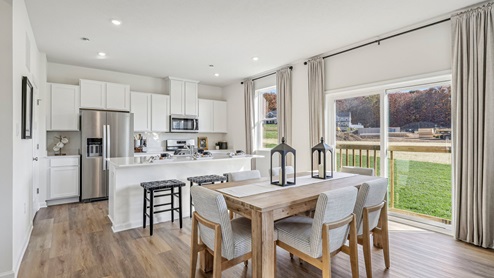 Deerfield First floor eat-in dining and kitchen areas with large windows and sliding glass doors