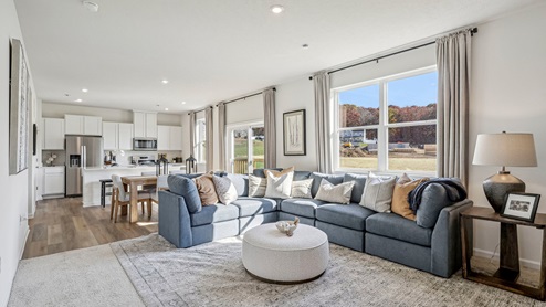 First floor living room with large windows and LVP flooring