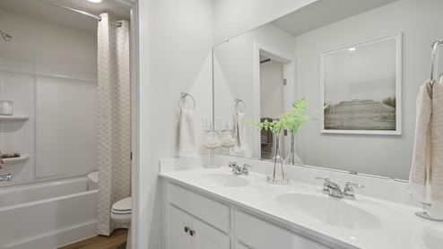 secondary bathroom with dual vanity