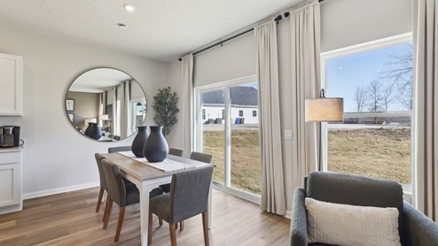 Dining area off of kitchen and living room with sliding glass doors