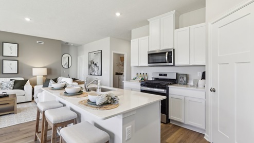 Corner kitchen with white cabinets and quartz countertops