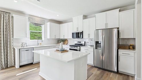 Kitchen with white cabinets and countertops