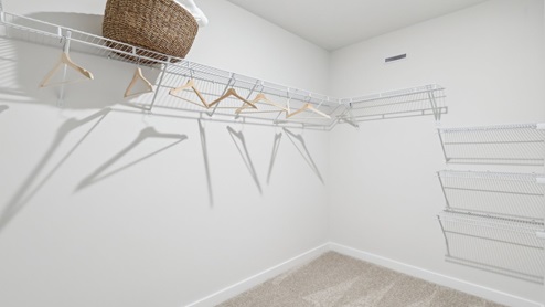 Primary walk-in closet with coated wire shelving