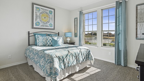 Bedroom with windows and blue decor