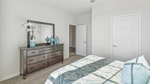 Bedroom with windows and blue decor