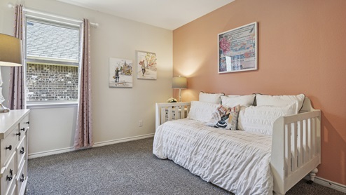 Bedroom with window and orange accent wall