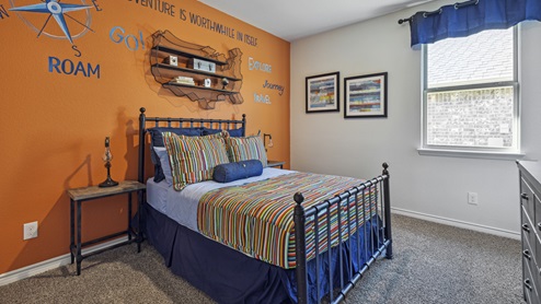 Bedroom with window and orange accent wall