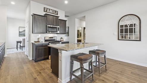 Kitchen with island and brown cabinets