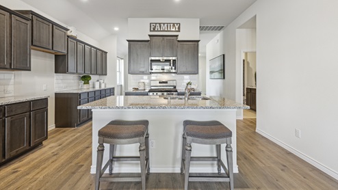 Kitchen with island and brown cabinets