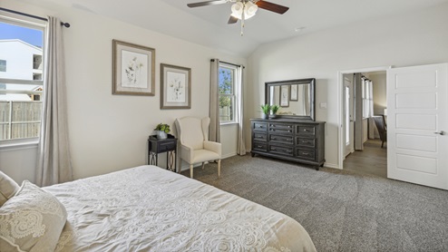 Large primary bedroom with accent wall and bedroom furniture