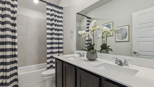 Secondary bathroom with elongated countertop and garden tub