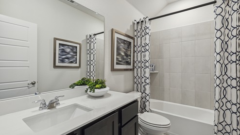 Secondary bathroom with elongated countertop and garden tub