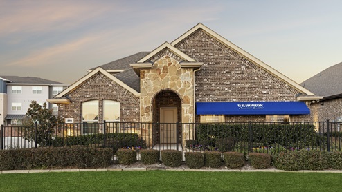 Sales office model with landscaping and blue D.R. Horton awning