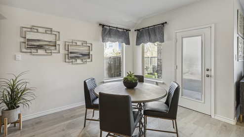 Kitchen nook with windows, back door and 4 seat breakfast table